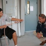 Felix completes a bowline with an overhand safety as he finishes the practical testing, while Assistant Chief Kevin Sasser looks on.